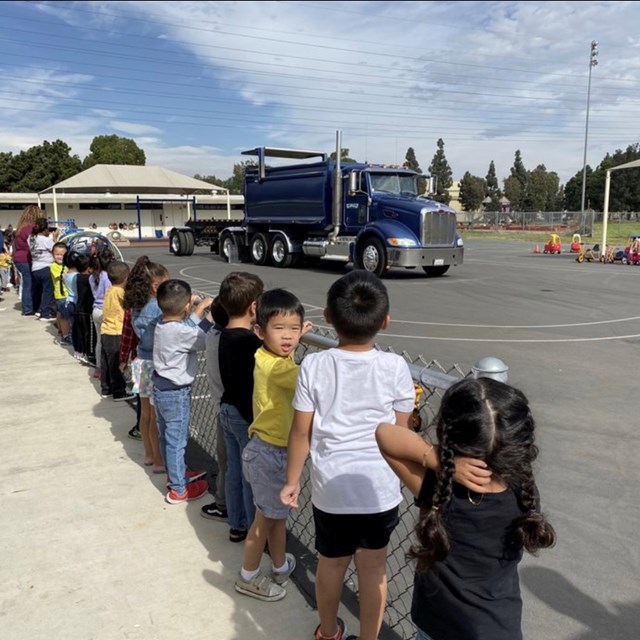 Students lined up to watch a truck show how it works!