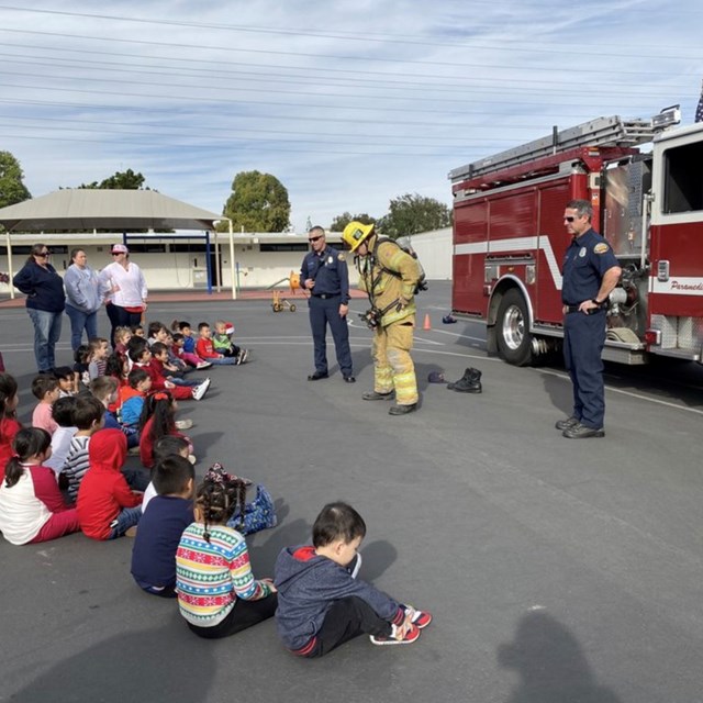 Firemen demonstrating fire fighting gear!