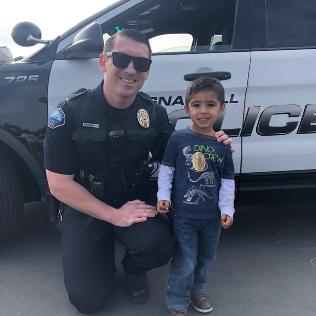 A Police Officer poses for a picture.